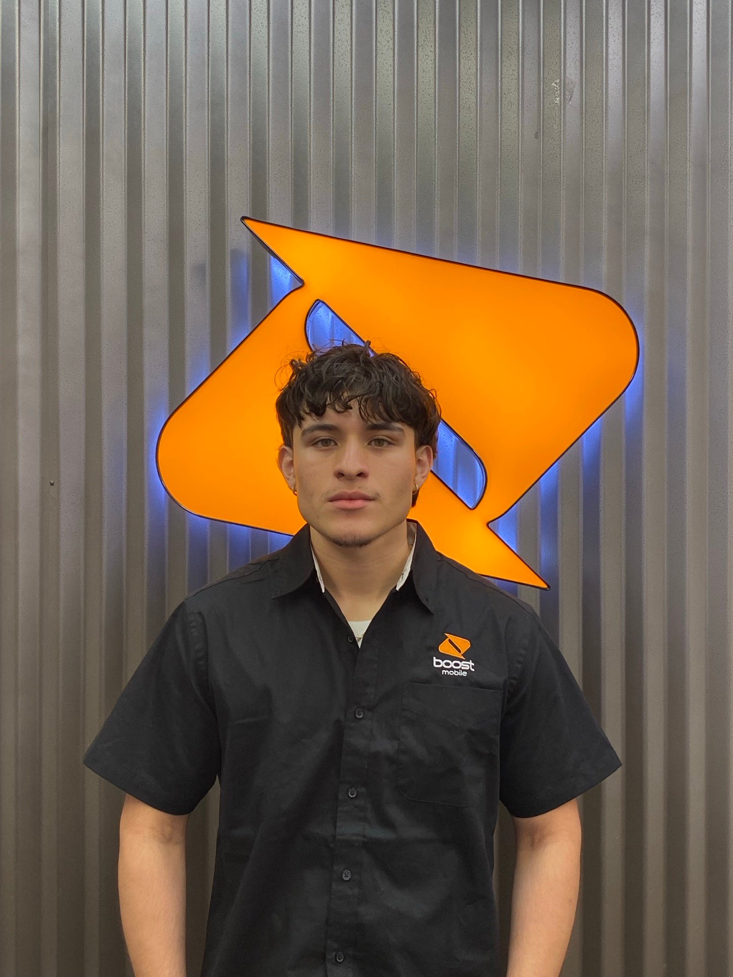 An RBFC team member in front of the Boost Mobile logo