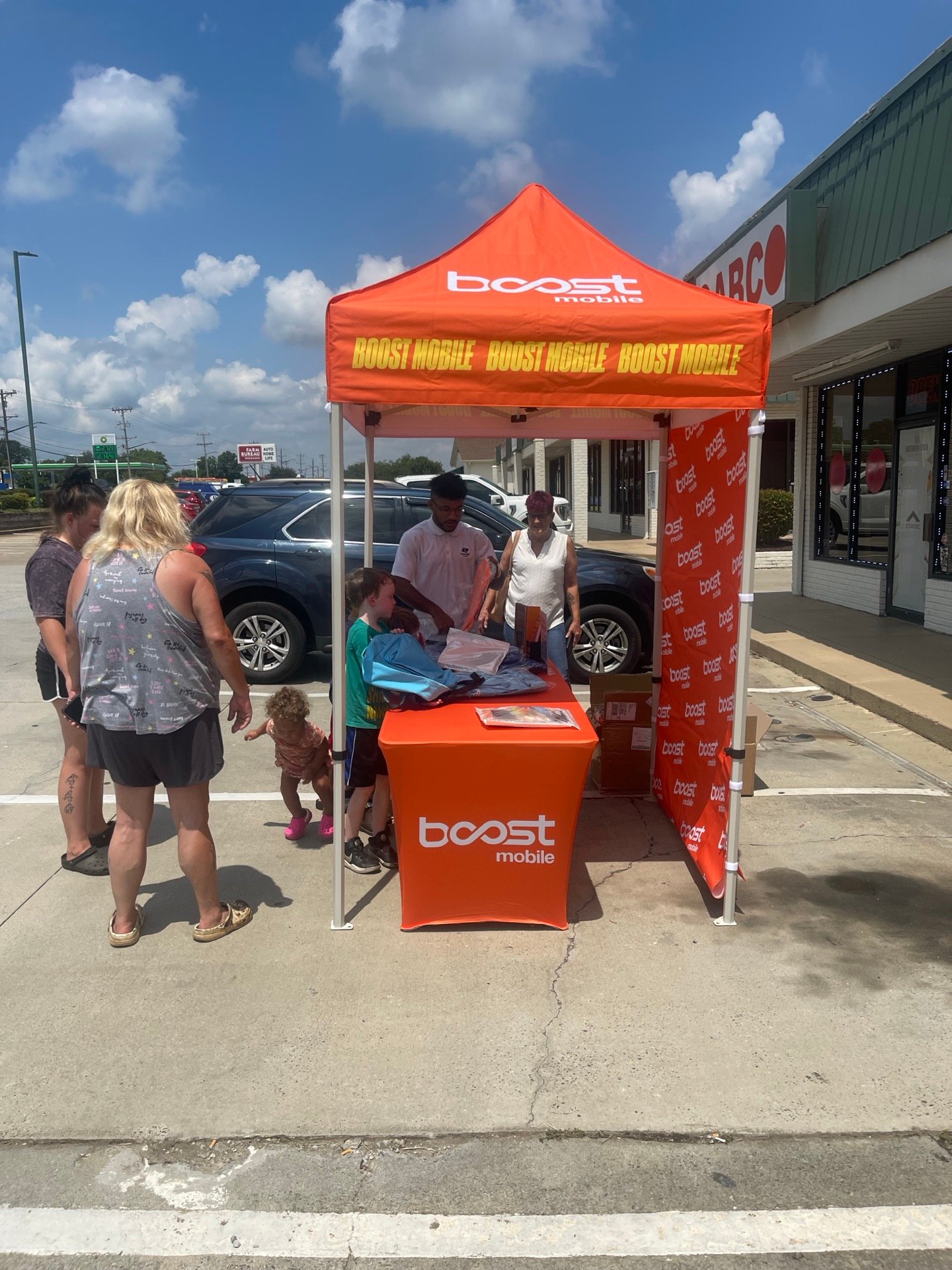 A local family stopping by an RBFC Boost Mobile community tent