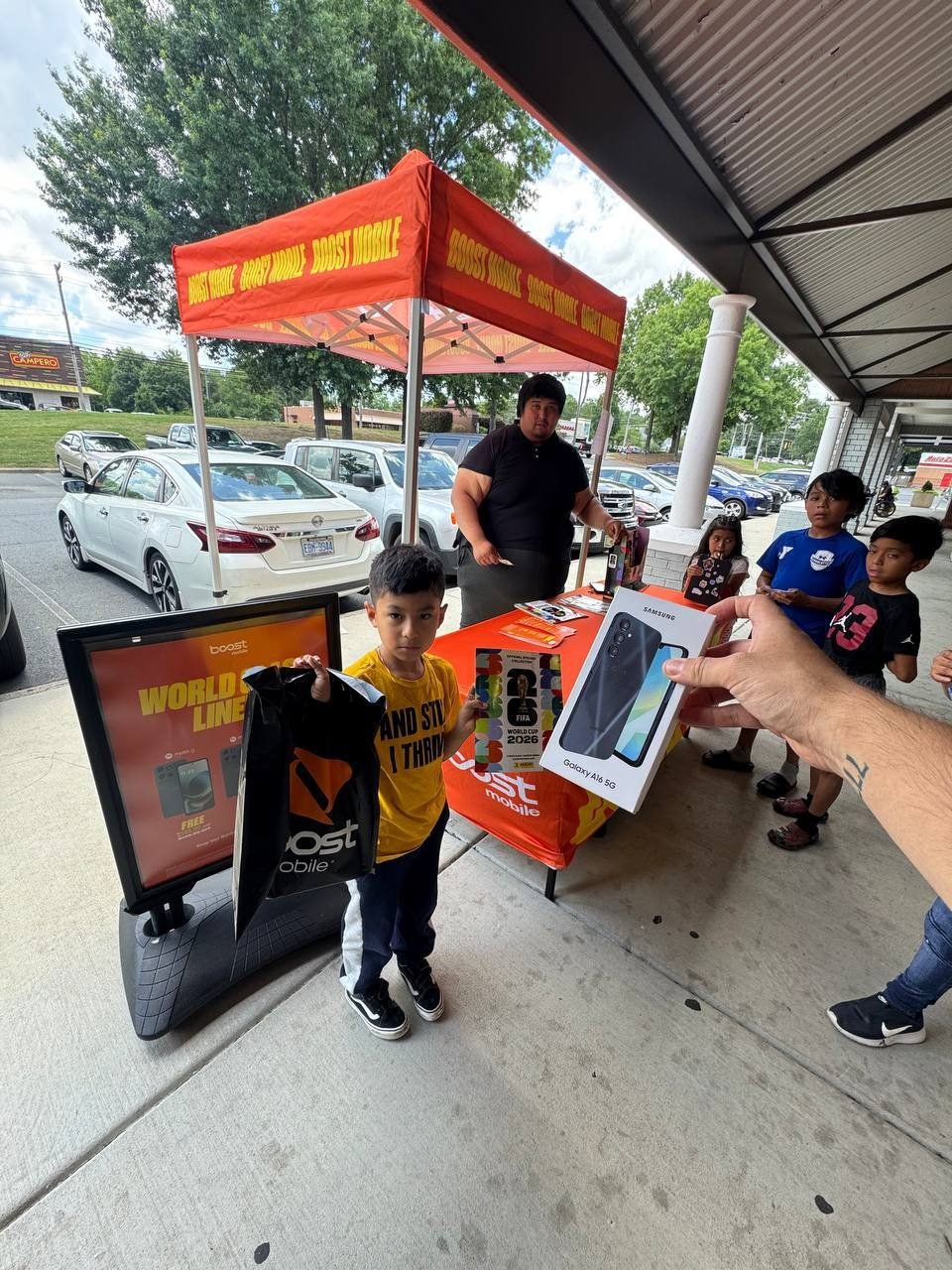 A young customer picking up a new phone at an RBFC pop-up