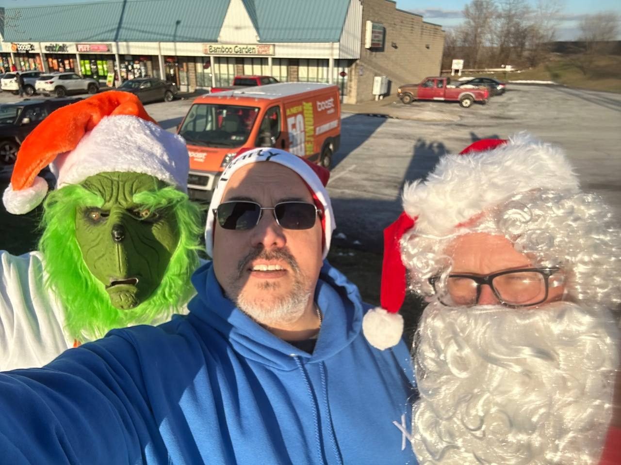 The RBFC team dressed as Santa and the Grinch outside the store
