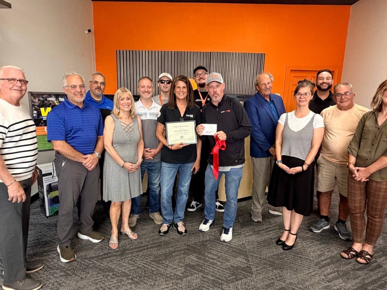 A ribbon cutting with local leaders at a new RBFC Boost Mobile store