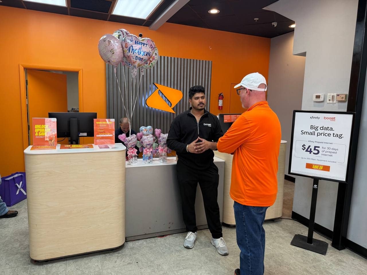 An RBFC associate handing a customer a gift at the counter